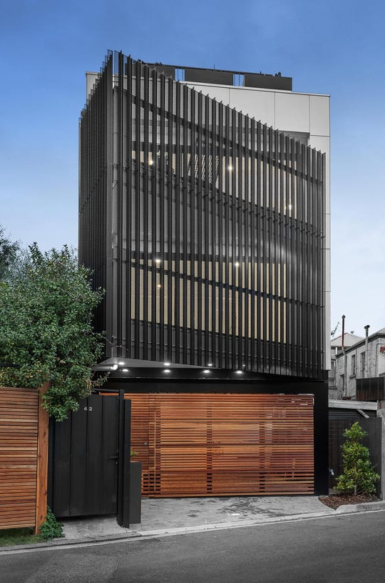 The Hawthorn House, Little Church St, Hawthorn: multi storey townhouse with a vertical batten screen facade and timber garage door, built by Silverfox Management